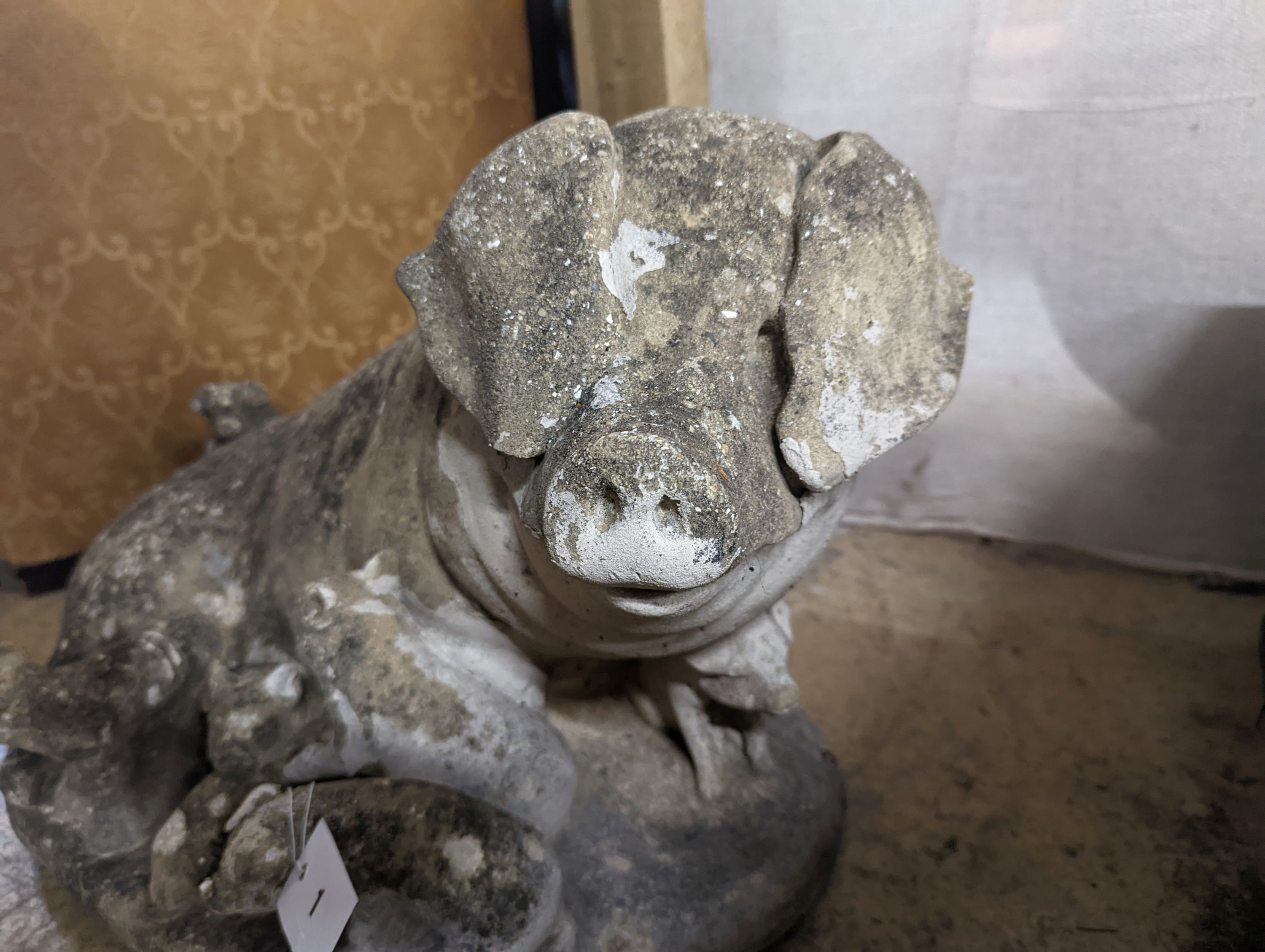 A reconstituted stone garden ornament of a sow with piglets, width 56cm, height 35cm